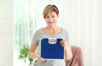 woman holding weighing scale